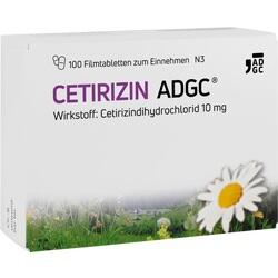 Schachtel mit Tabletten gegen Allergien, daneben Blume auf Wiese.